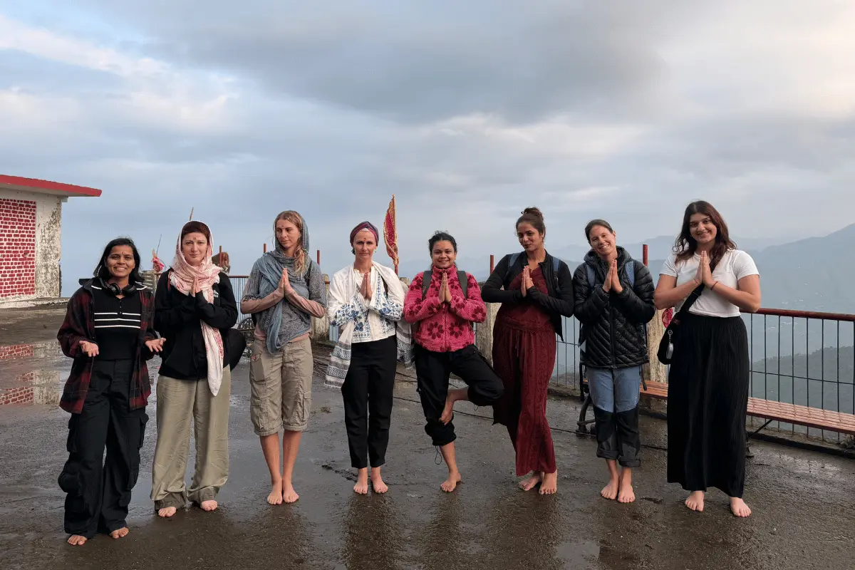 Yoga students practicing namaste pose at Kunjapuri Temple excursion during 200 Hour Yoga TTC in Rishikesh