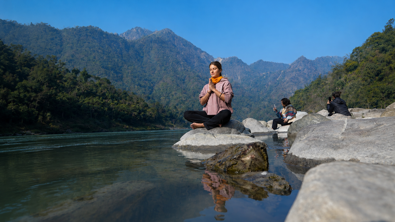 Meditation practice by the Himalayan riverside during a 7 Day Himalayan Yoga and Meditation Retreat in Rishikesh, India
