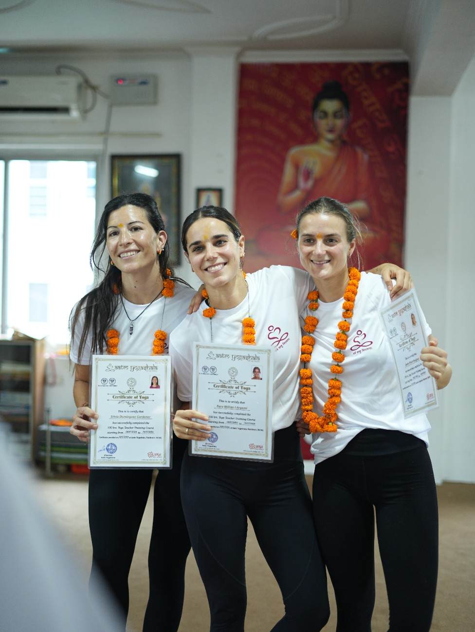 Yoga Teacher Training graduates holding certificates at Aatm Yogashala in Rishikesh