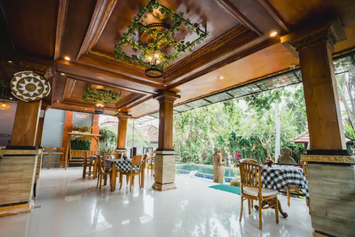 Outdoor dining area with pool view at Aatm Yogashala Bali yoga retreat