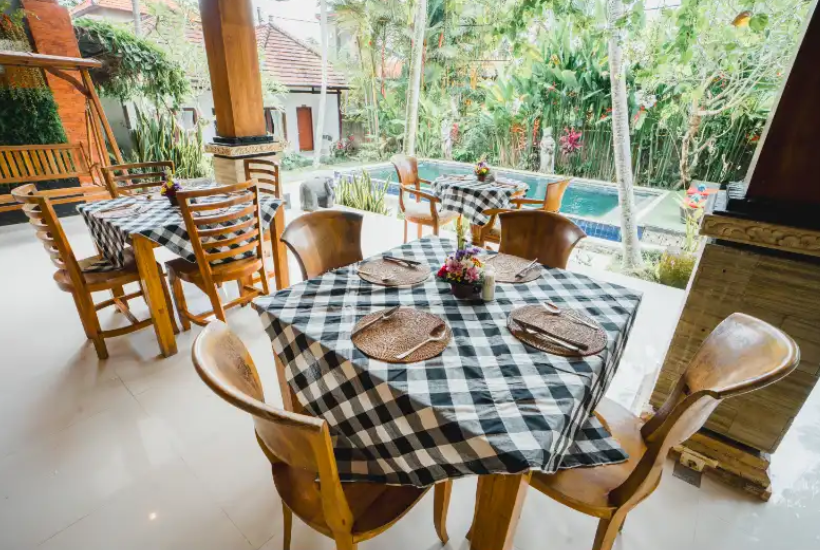 outdoor dining area with pool view at Aatm Yogashala Bali yoga retreat