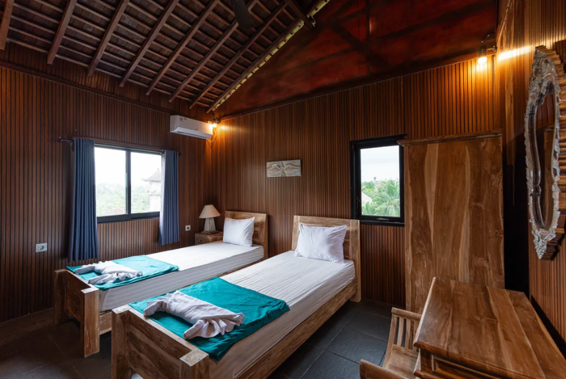 wooden twin room with two single beds at Aatm Yogashala Bali TTC
