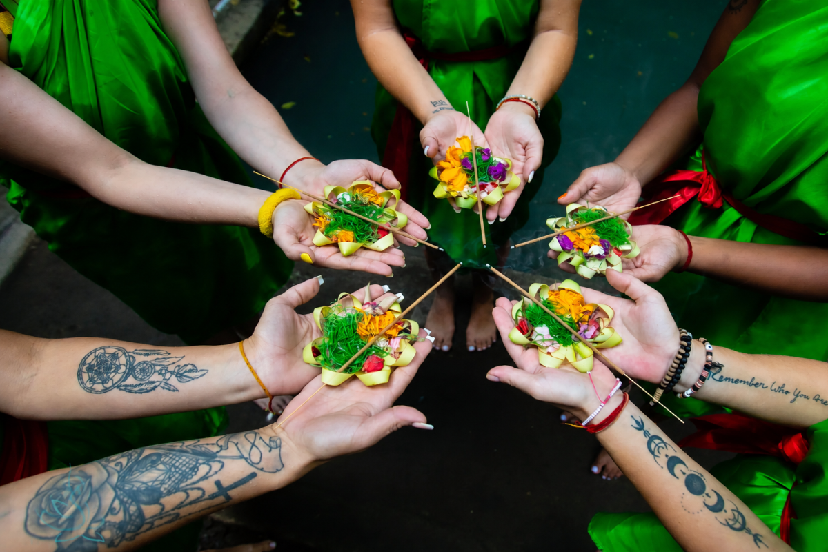 Students taking part in a traditional group offerings ceremony during the 100 Hour Yoga Teacher Training in Bali