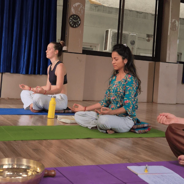 Guided sound healing meditation class with students in Rishikesh India