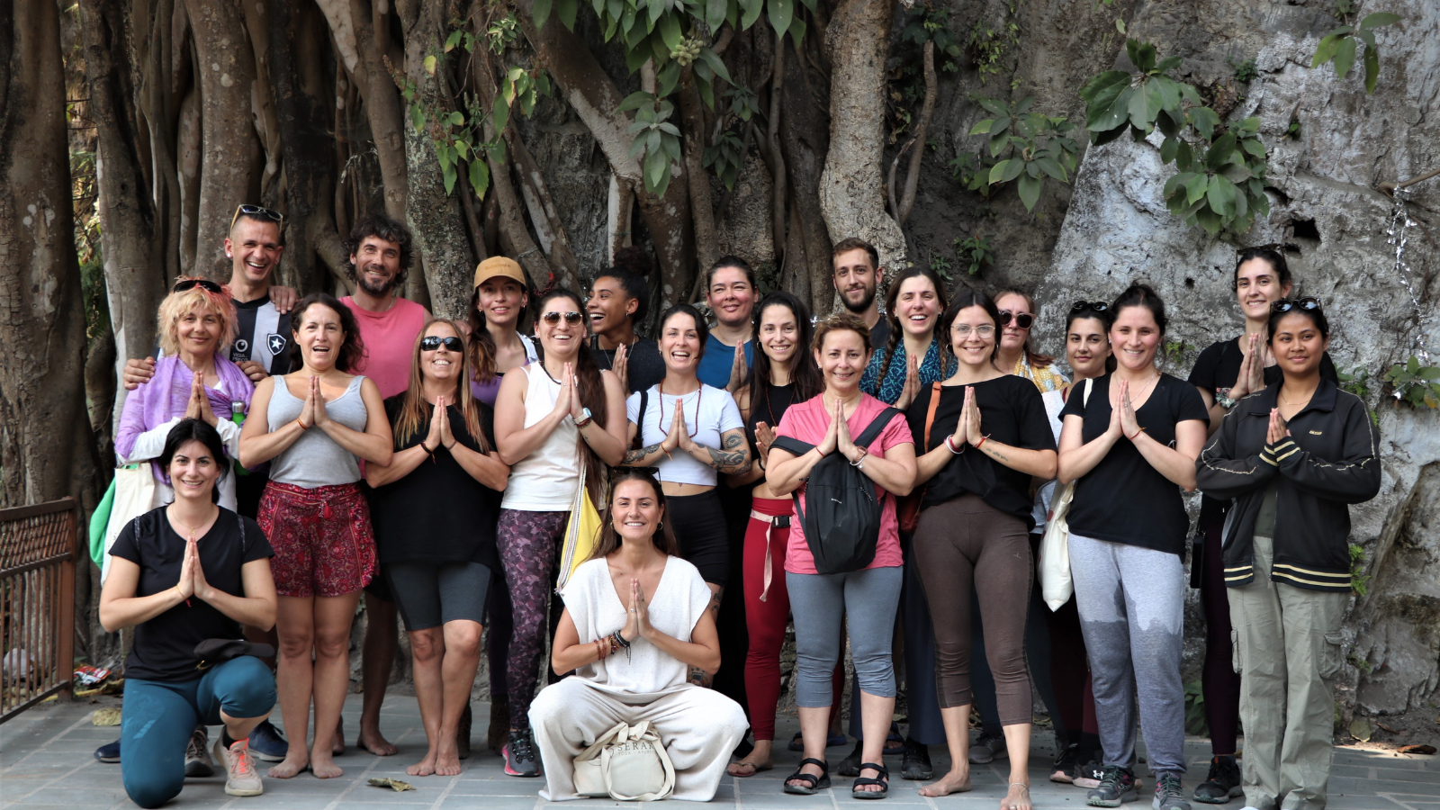 International yoga retreat students group photo in Rishikesh India surrounded by nature