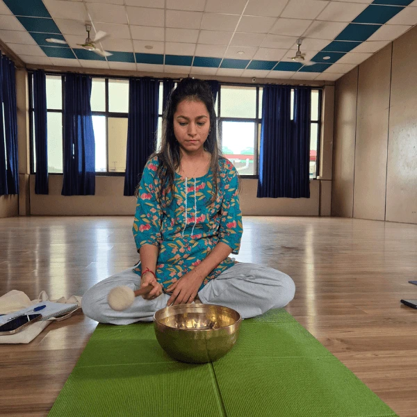 Tibetan singing bowl training session during sound healing teacher training in Rishikesh