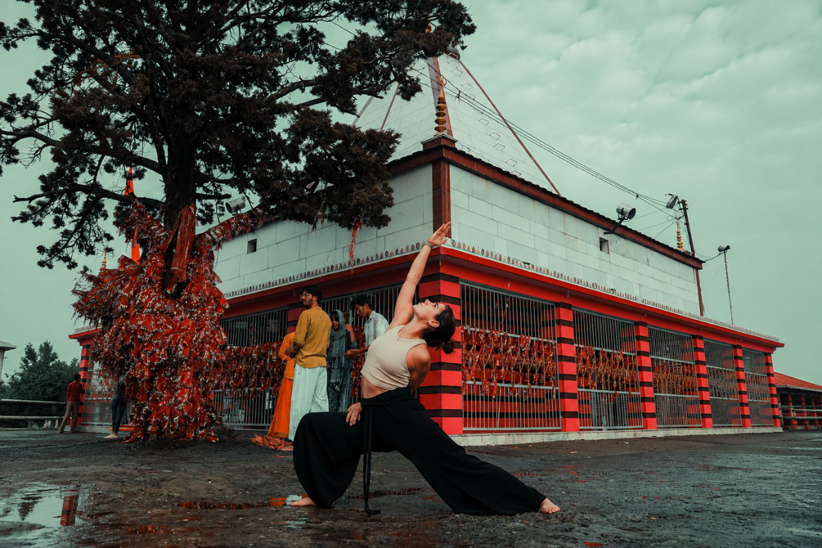 Yoga student practicing lunge stretch pose at Kunjapuri Temple excursion during 100 Hour Yoga Teacher Training in Rishikesh