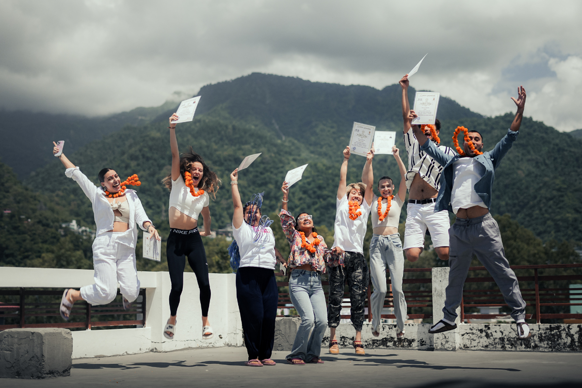 Yoga students celebrating with certificates after completing 100 Hour Yoga Teacher Training at Aatm Yogashala Rishikesh