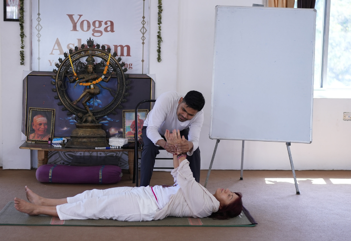 Yoga therapy practical training session with instructor and student in Rishikesh India
